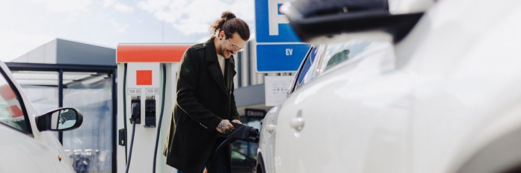 Person charging their electric vehicle