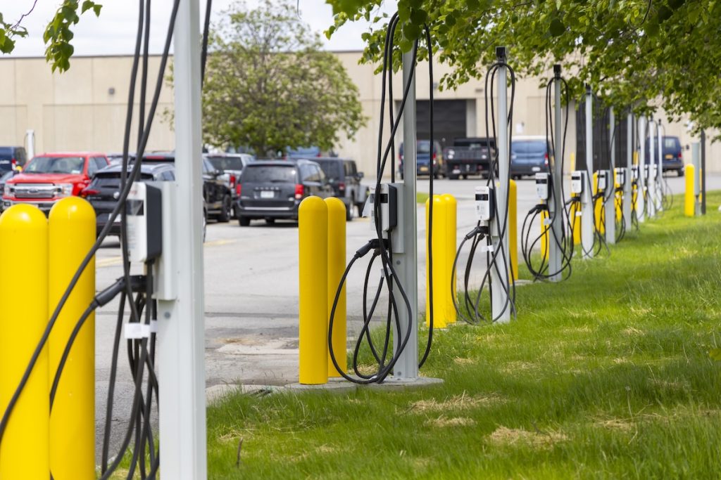 A row of charging stations in a parking lot. 